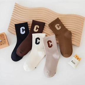 meia infantil malha em algodão kit com 5 pares vistas de cima em um fundo branco.